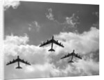 1950s three B-52 bomber airplanes in flight formation by Anonymous
