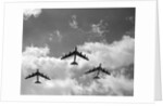 1950s three B-52 bomber airplanes in flight formation by Anonymous