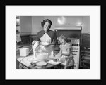 1950s mother and daughter baking a cake by Anonymous