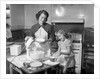 1950s mother and daughter baking a cake by Anonymous