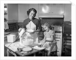 1950s mother and daughter baking a cake by Anonymous