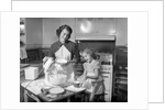 1950s mother and daughter baking a cake by Anonymous