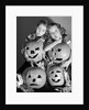 1950s boy and girl with four jack-o-lanterns by Anonymous