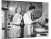 1950s smiling couple washing the dishes together by Anonymous
