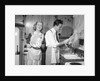 1950s smiling couple washing the dishes together by Anonymous
