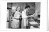 1950s smiling couple washing the dishes together by Anonymous
