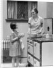 1920s young girl helping her mother to cook by Anonymous
