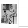 1920s young girl helping her mother to cook by Anonymous