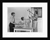 1940s housewife in kitchen showing plucked turkey to children by Anonymous