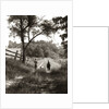 1930s boy and girl in straw hats walking down farm road by Anonymous
