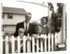 1950s family of four behind picket fence by Anonymous