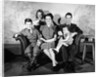 1930s 1940s family of five on a couch by Anonymous