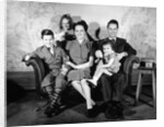 1930s 1940s family of five on a couch by Anonymous