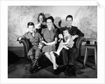 1930s 1940s family of five on a couch by Anonymous