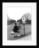 1930s 1940s boy and girl waiting to cross the road by Anonymous
