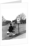 1930s 1940s boy and girl waiting to cross the road by Anonymous
