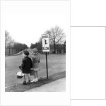 1930s 1940s boy and girl waiting to cross the road by Anonymous