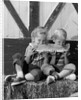 1960s boy and girl sharing a slice of watermelon by Anonymous