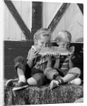 1960s boy and girl sharing a slice of watermelon by Anonymous