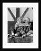 1960s boy and girl sharing a slice of watermelon by Anonymous