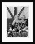 1960s boy and girl sharing a slice of watermelon by Anonymous