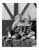 1960s boy and girl sharing a slice of watermelon by Anonymous