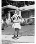 1950s girl on suburban sidewalk playing with a hula hoop by Anonymous