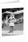 1950s girl on suburban sidewalk playing with a hula hoop by Anonymous