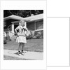 1950s girl on suburban sidewalk playing with a hula hoop by Anonymous
