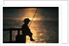 Silhouette of child fishing off a dock at sunset by Anonymous
