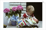 1970s boy holding a newborn baby by Anonymous