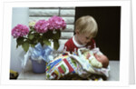1970s boy holding a newborn baby by Anonymous