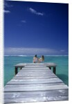 couple Sitting On A Pier In An Ocean Lagoon by Anonymous