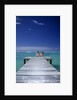 couple Sitting On A Pier In An Ocean Lagoon by Anonymous