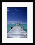 couple Sitting On A Pier In An Ocean Lagoon by Anonymous