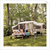 1970s family having picnic by camper by Anonymous