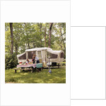 1970s family having picnic by camper by Anonymous