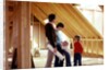1980s family of four inspecting new home under construction by Anonymous