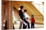 1980s family of four inspecting new home under construction by Anonymous