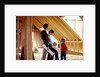 1980s family of four inspecting new home under construction by Anonymous
