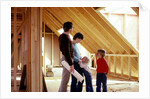 1980s family of four inspecting new home under construction by Anonymous