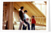 1980s family of four inspecting new home under construction by Anonymous