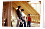 1980s family of four inspecting new home under construction by Anonymous