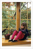 Little girl reading at home by Anonymous