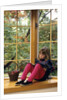 Little girl reading at home by Anonymous