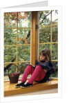 Little girl reading at home by Anonymous