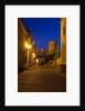 Streets of Banos de la Encina at night with the Moorish castle, named Burgalimar Castle, in the back by Anonymous