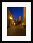Streets of Banos de la Encina at night with the Moorish castle, named Burgalimar Castle, in the back by Anonymous