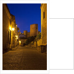Streets of Banos de la Encina at night with the Moorish castle, named Burgalimar Castle, in the back by Anonymous