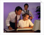 Business people working together at desktop computer by Anonymous